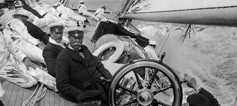 Noblesse Yachts Sir Thomas Lipton on the helm of one of its SHARMROCKs